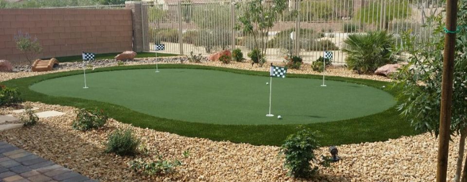 Backyard putting green with holes and flags.