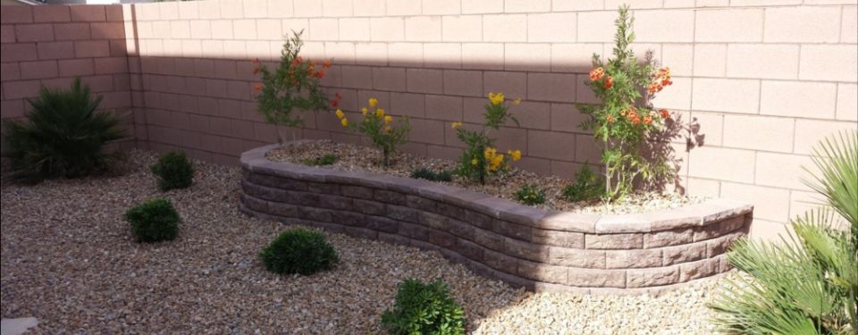 Enclosed backyard with a flower bed.